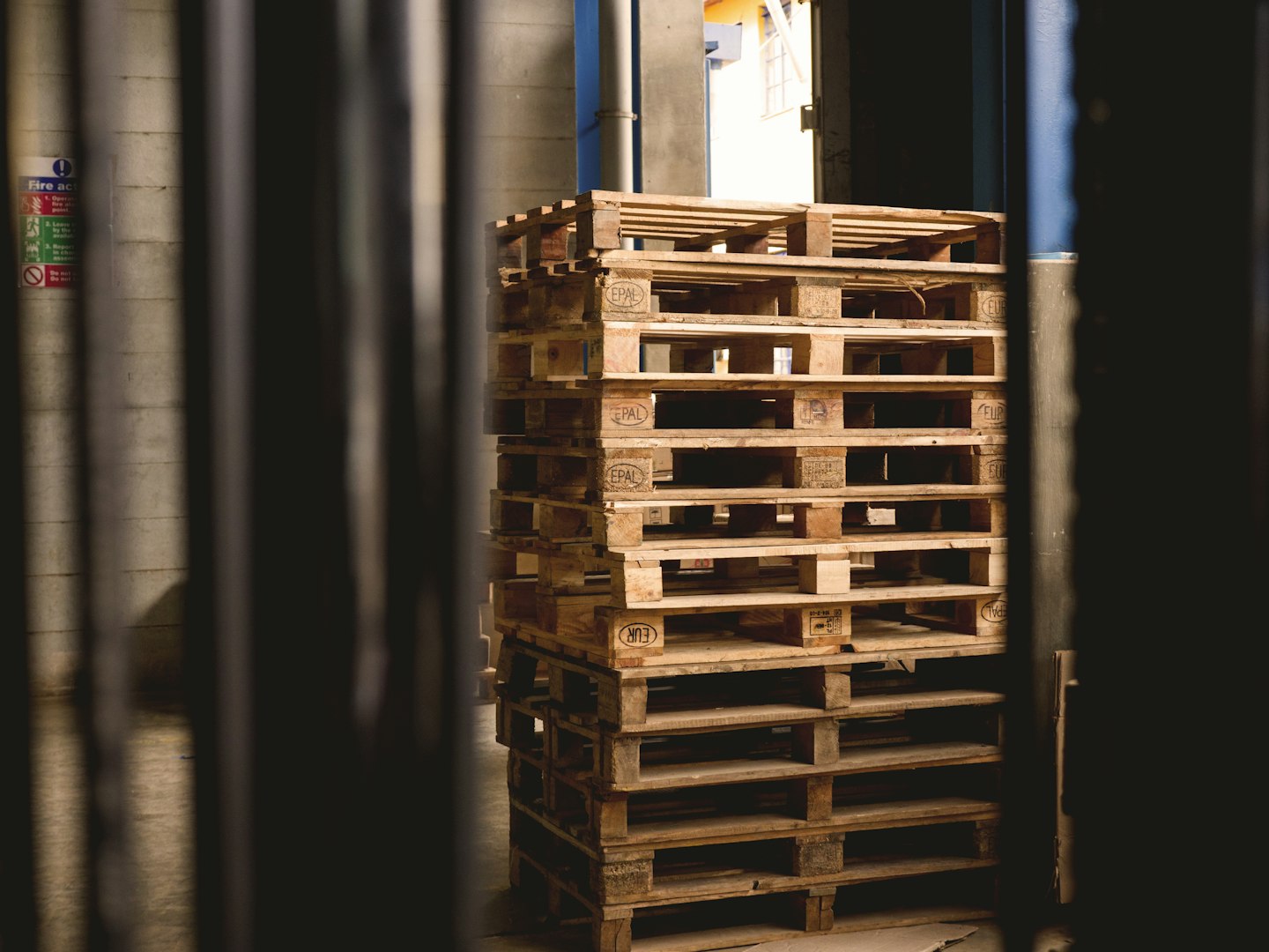 A stack of empty pallets in a warehouse facility